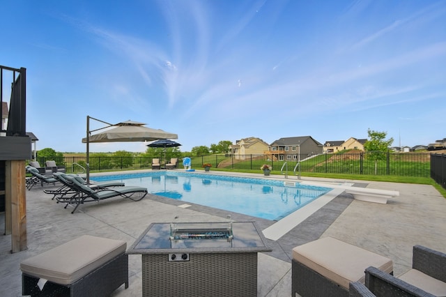 2216 Timberview Dr, Norwalk, IA 50211 - view of swimming pool featuring a patio, a fenced backyard, and an outdoor fire pit