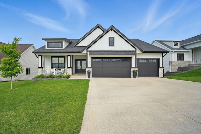 2216 Timberview Dr, Norwalk, IA 50211 - modern farmhouse style home with board and batten siding, a garage, a front lawn, and concrete driveway