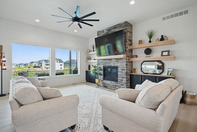 2216 Timberview Dr, Norwalk, IA 50211 - living room with a ceiling fan, wood finished floors, a fireplace, recessed lighting, and baseboards