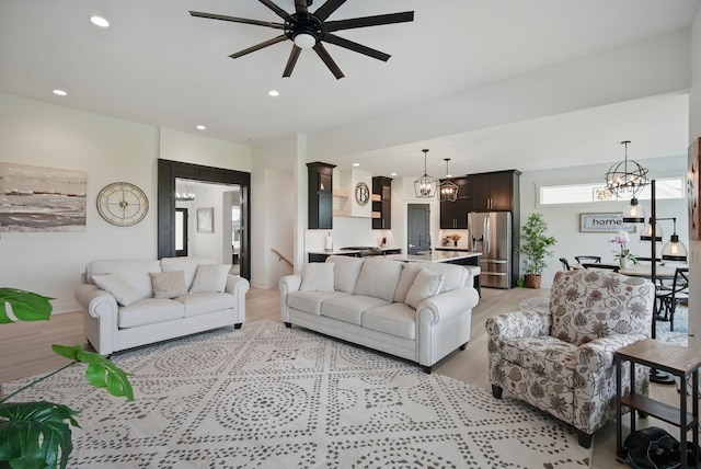2216 Timberview Dr, Norwalk, IA 50211 - living area featuring a chandelier, light wood-type flooring, a ceiling fan, and recessed lighting