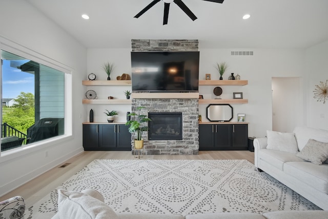 2216 Timberview Dr, Norwalk, IA 50211 - living room with ceiling fan, light wood finished floors, a fireplace, and recessed lighting