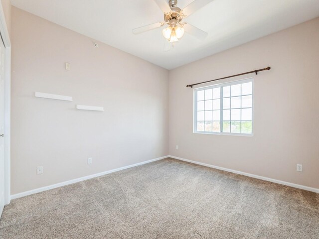 6255 Beechtree Dr Unit 4304, West Des Moines, IA 50266 - spare room featuring carpet floors, baseboards, and a ceiling fan