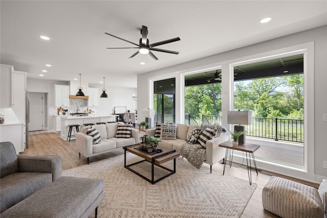9814 Watermeadow Cir, Johnston, IA 50131 - living area featuring ceiling fan, light wood finished floors, and recessed lighting