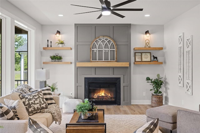 9814 Watermeadow Cir, Johnston, IA 50131 - living room featuring ceiling fan, wood finished floors, a fireplace, and recessed lighting