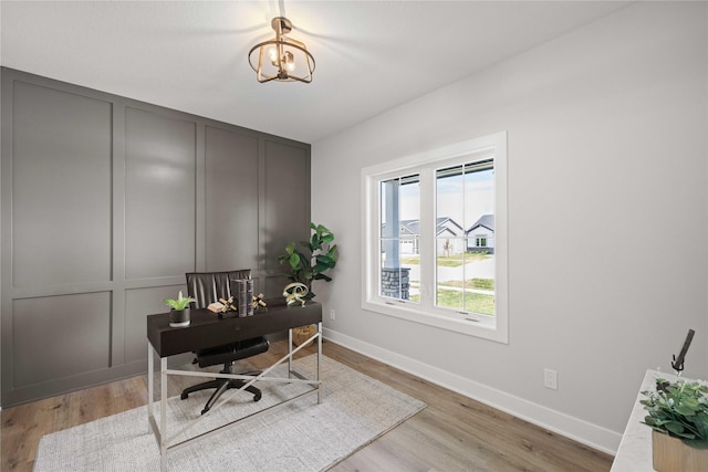 9814 Watermeadow Cir, Johnston, IA 50131 - home office featuring baseboards, wood finished floors, and a chandelier