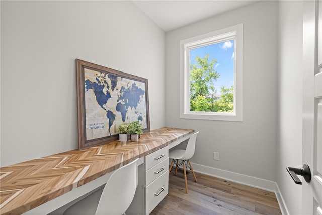 9814 Watermeadow Cir, Johnston, IA 50131 - office space featuring built in desk, light wood-style flooring, and baseboards