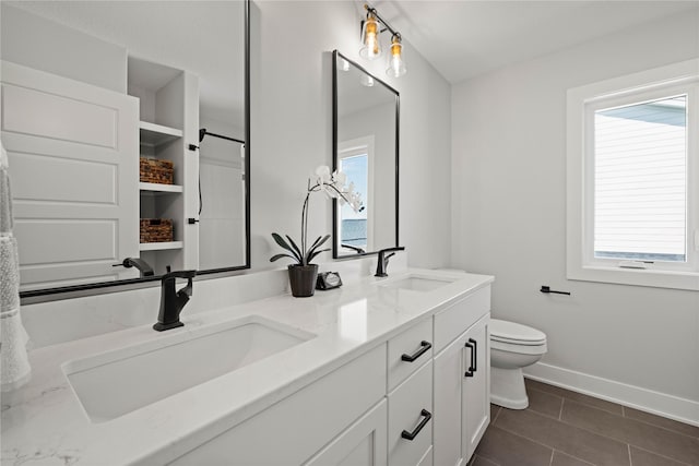 9814 Watermeadow Cir, Johnston, IA 50131 - full bath featuring baseboards, double vanity, toilet, and healthy amount of natural light
