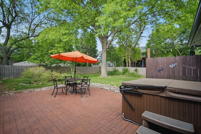 711 36th St, West Des Moines, IA 50265 - view of patio / terrace with a hot tub and outdoor dining area