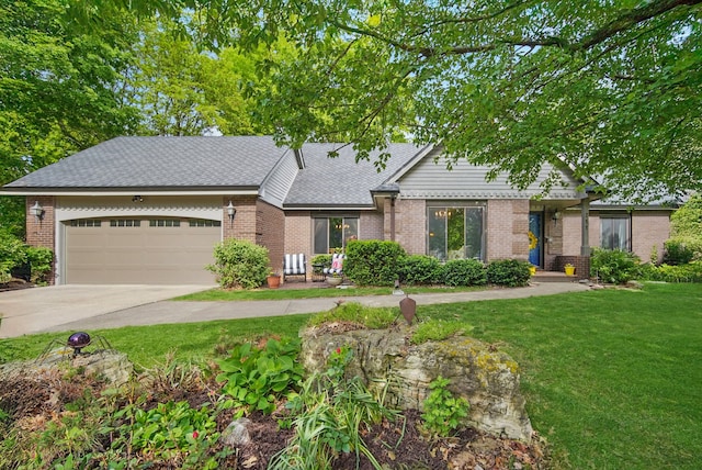711 36th St, West Des Moines, IA 50265 - view of front of property featuring brick siding, a front yard, a garage, and concrete driveway