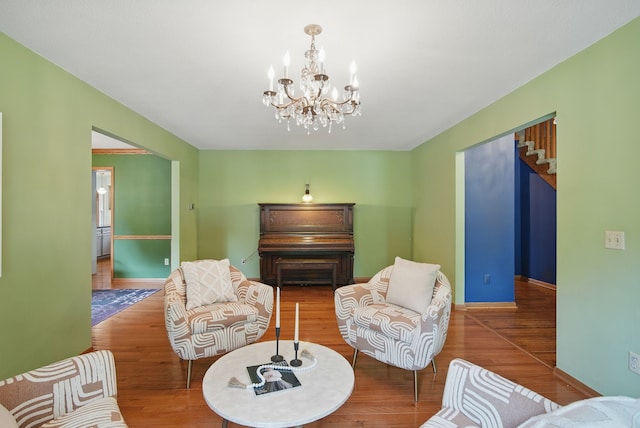 711 36th St, West Des Moines, IA 50265 - living room featuring wood finished floors, a chandelier, and baseboards