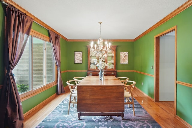 711 36th St, West Des Moines, IA 50265 - dining area featuring a chandelier, wood finished floors, plenty of natural light, and crown molding
