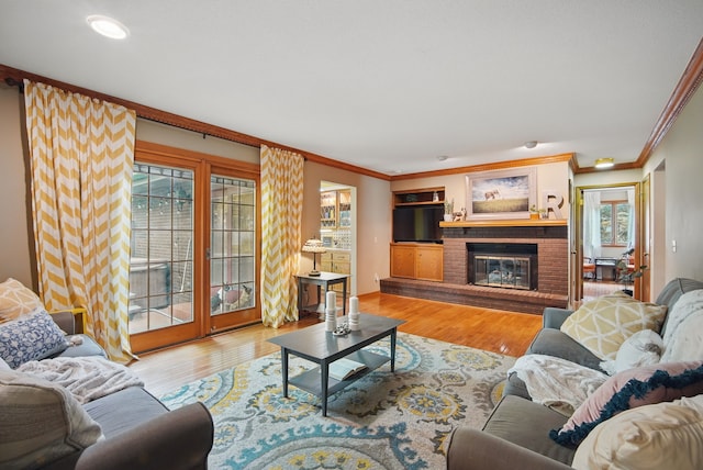 711 36th St, West Des Moines, IA 50265 - living area featuring crown molding, wood finished floors, and a brick fireplace