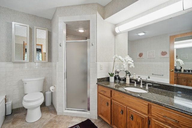 711 36th St, West Des Moines, IA 50265 - bathroom with tile walls, toilet, vanity, a shower stall, and tile patterned floors