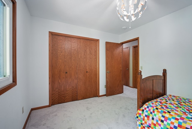 711 36th St, West Des Moines, IA 50265 - bedroom with carpet floors, a chandelier, a closet, and baseboards