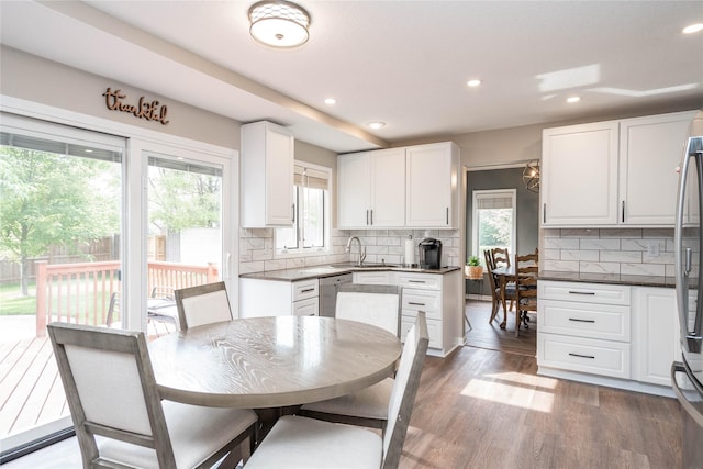 6640 Monticello Ct, Johnston, IA 50131 - kitchen with a sink, white cabinetry, backsplash, dark wood-style floors, and recessed lighting