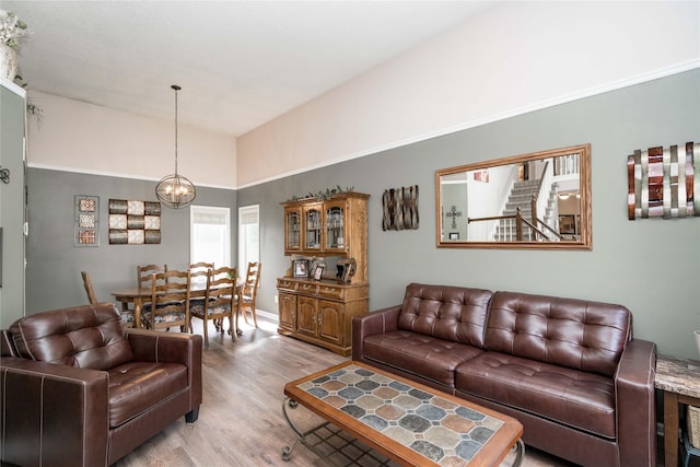 6640 Monticello Ct, Johnston, IA 50131 - living area featuring a chandelier, light wood-style floors, and vaulted ceiling