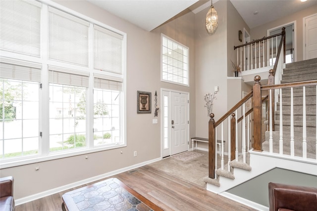 6640 Monticello Ct, Johnston, IA 50131 - foyer with wood finished floors, stairs, baseboards, and a high ceiling