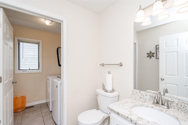 6640 Monticello Ct, Johnston, IA 50131 - bathroom with separate washer and dryer, vanity, tile patterned flooring, toilet, and baseboards