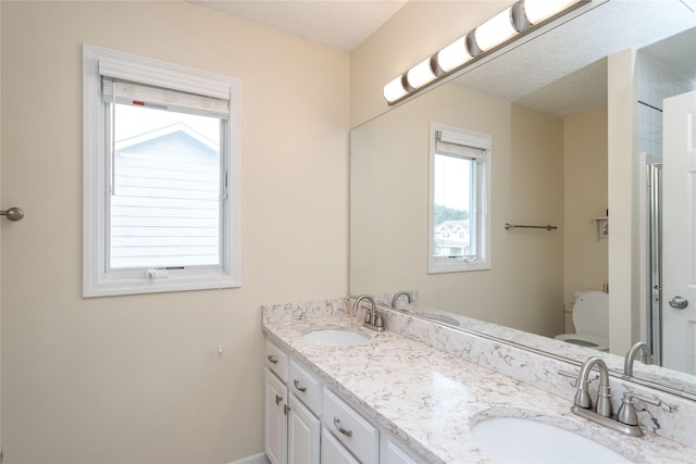 6640 Monticello Ct, Johnston, IA 50131 - full bath featuring double vanity, toilet, and baseboards