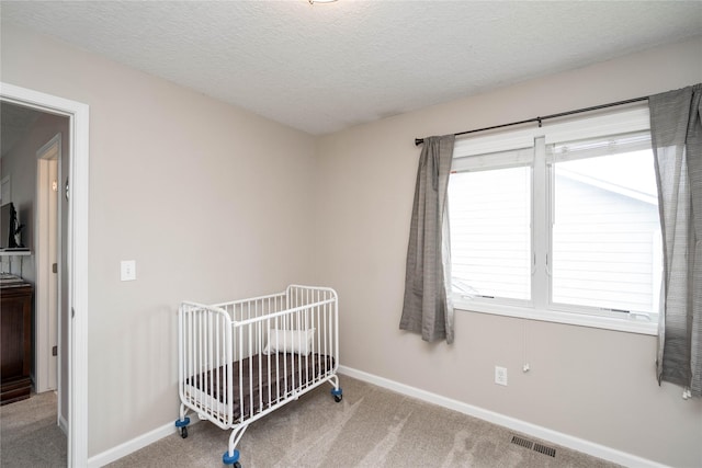 6640 Monticello Ct, Johnston, IA 50131 - carpeted bedroom with baseboards, a nursery area, and a textured ceiling