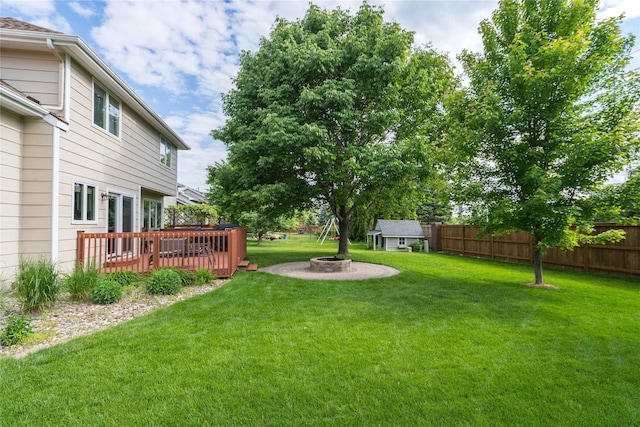 6640 Monticello Ct, Johnston, IA 50131 - view of yard with a wooden deck, an outdoor fire pit, and an outbuilding