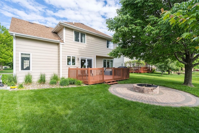 6640 Monticello Ct, Johnston, IA 50131 - rear view of house featuring an outdoor fire pit, a deck, and a yard
