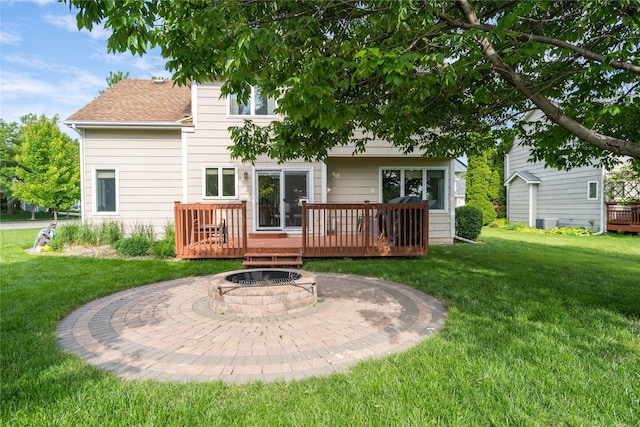 6640 Monticello Ct, Johnston, IA 50131 - rear view of house featuring a wooden deck, a fire pit, a yard, and roof with shingles