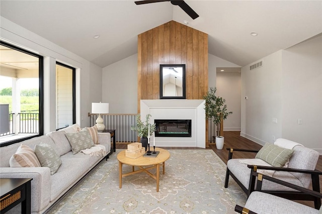 1511 Boulder Creek Ct SE, Altoona, IA 50009 - living area with lofted ceiling, ceiling fan, wood finished floors, a glass covered fireplace, and baseboards