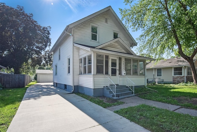 3421 Amherst St, Des Moines, IA 50313 - view of front of house featuring a sunroom and an outbuilding