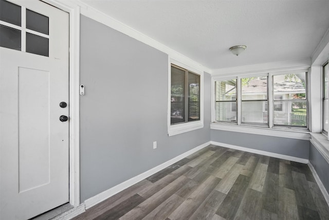 3421 Amherst St, Des Moines, IA 50313 - unfurnished sunroom featuring wood finished floors, baseboards, and a textured ceiling