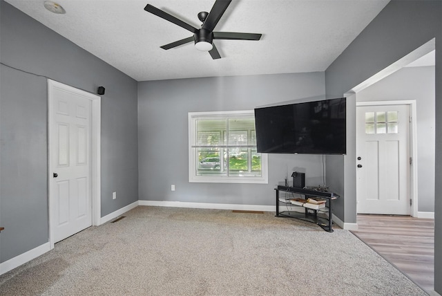 3421 Amherst St, Des Moines, IA 50313 - unfurnished living room with ceiling fan, carpet floors, and baseboards