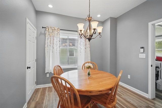 3421 Amherst St, Des Moines, IA 50313 - dining space with a chandelier, light wood-style flooring, baseboards, and recessed lighting
