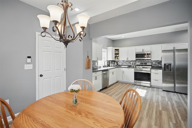 3421 Amherst St, Des Moines, IA 50313 - dining space featuring a chandelier, light wood finished floors, and recessed lighting