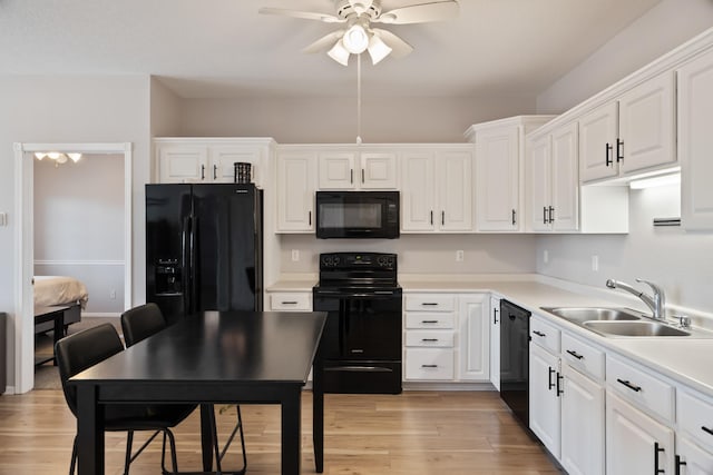 1335 SE Florence Dr Unit 312, Waukee, IA 50263 - kitchen featuring black appliances, a sink, ceiling fan, white cabinetry, and light wood-type flooring