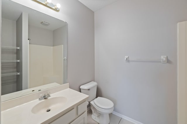 1335 SE Florence Dr Unit 312, Waukee, IA 50263 - full bath featuring vanity, toilet, a shower, tile patterned flooring, and baseboards