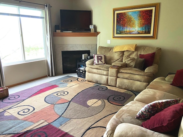 1740 SE La Grant Pkwy Unit 18, Waukee, IA 50263 - carpeted living room with a tiled fireplace and baseboards
