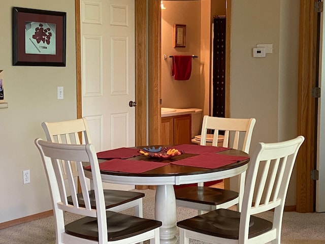 1740 SE La Grant Pkwy Unit 18, Waukee, IA 50263 - dining area with light carpet and baseboards