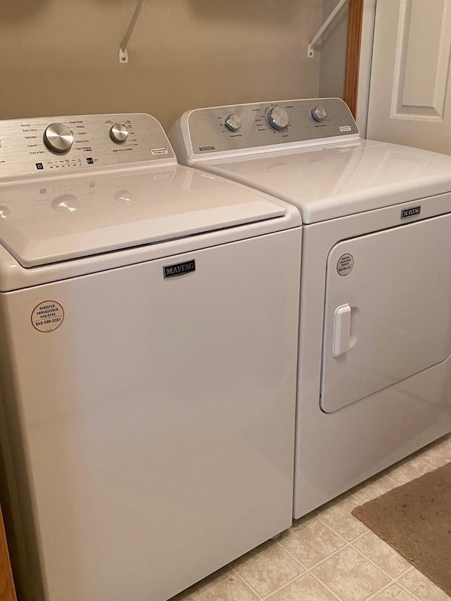1740 SE La Grant Pkwy Unit 18, Waukee, IA 50263 - laundry area featuring independent washer and dryer and light tile patterned flooring