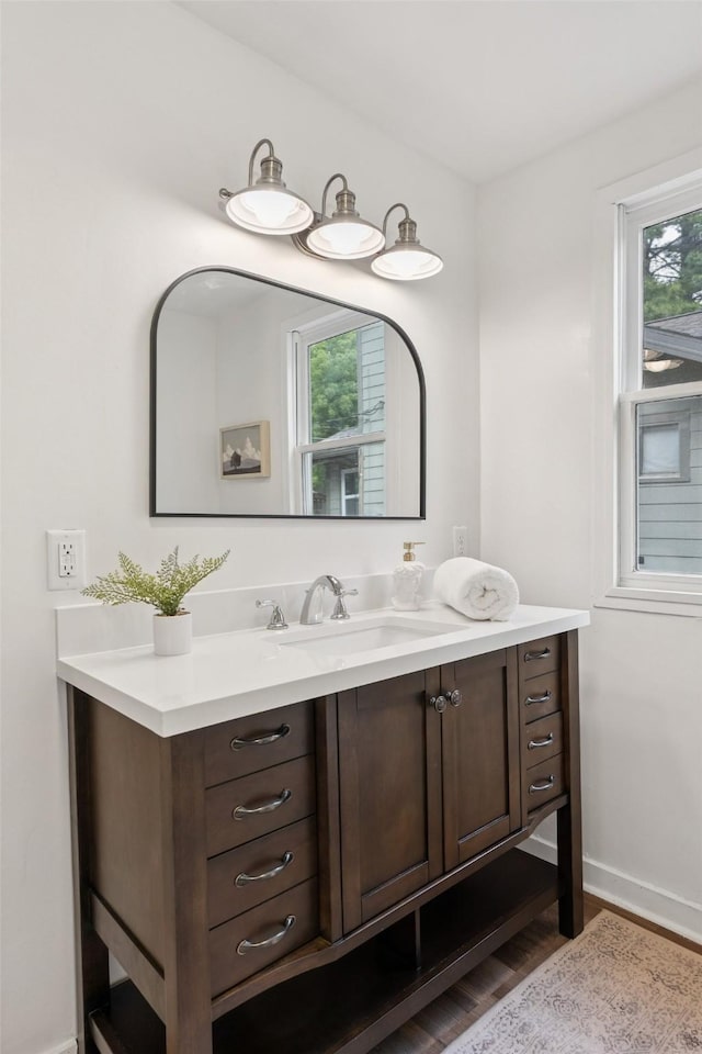 827 40th Pl, Des Moines, IA 50312 - bathroom with vanity and wood finished floors