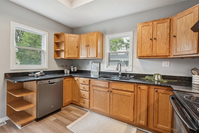 827 40th Pl, Des Moines, IA 50312 - kitchen with stainless steel appliances, open shelves, light wood-style flooring, and dark stone countertops