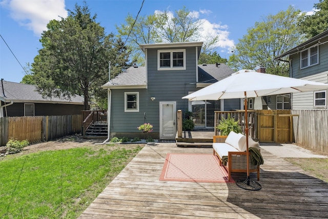 827 40th Pl, Des Moines, IA 50312 - rear view of property featuring a fenced backyard, a wooden deck, and a shingled roof