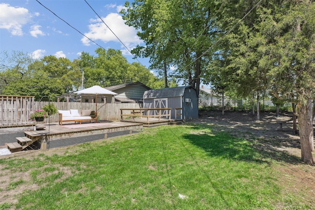 827 40th Pl, Des Moines, IA 50312 - fenced backyard featuring a storage shed, a wooden deck, and outdoor lounge area