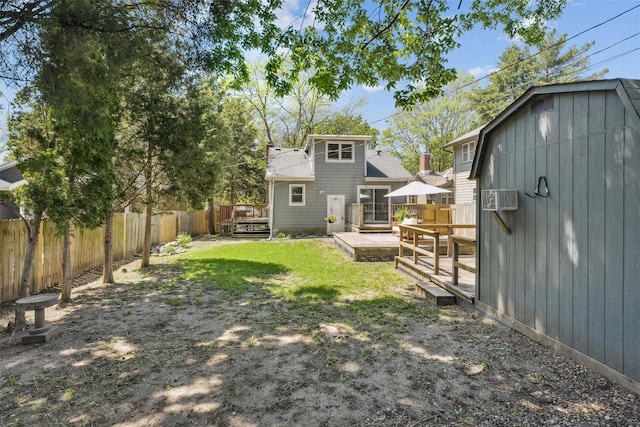 827 40th Pl, Des Moines, IA 50312 - back of house with a fenced backyard, a deck, and an outdoor structure