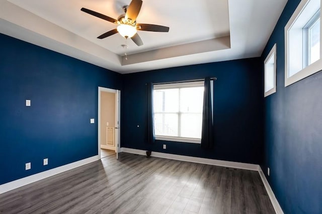 955 Spruce St, Waukee, IA 50263 - spare room featuring a tray ceiling, a ceiling fan, wood finished floors, and baseboards
