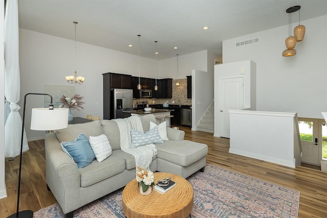 196 79th St, West Des Moines, IA 50266 - living area featuring a chandelier, wood finished floors, recessed lighting, and stairs
