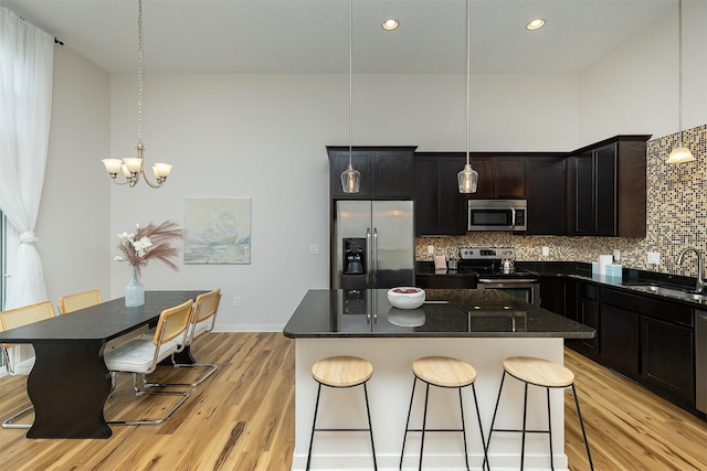 196 79th St, West Des Moines, IA 50266 - kitchen featuring appliances with stainless steel finishes, light wood-style floors, a sink, backsplash, and recessed lighting