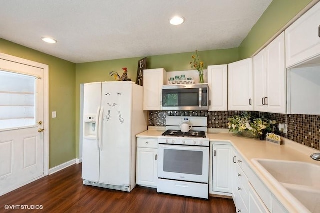 2638 Capitol Ave, Des Moines, IA 50317 - kitchen featuring white appliances, a sink, decorative backsplash, white cabinets, and recessed lighting