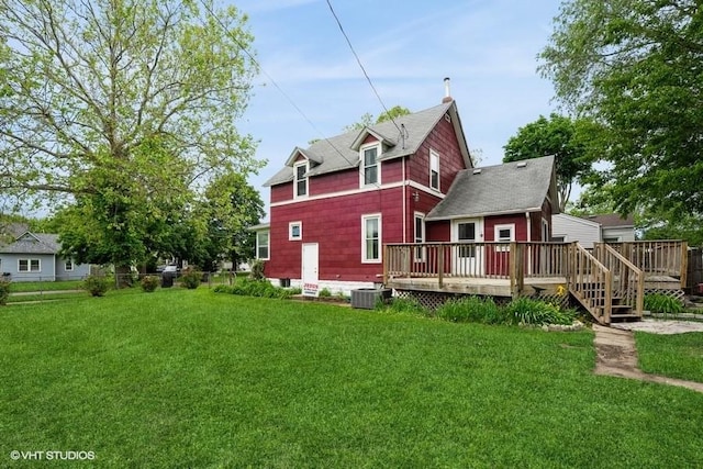 2638 Capitol Ave, Des Moines, IA 50317 - rear view of property with a wooden deck and a lawn