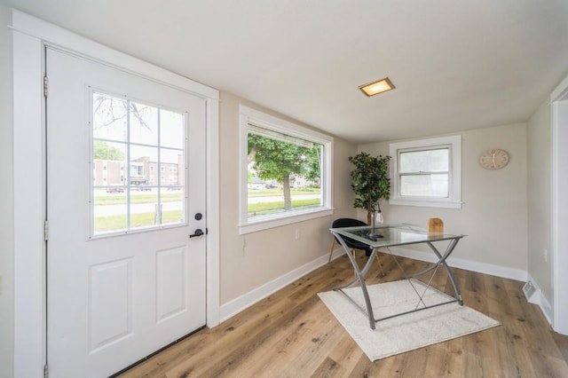 212 Nile Kinnick Dr N, Adel, IA 50003 - doorway with baseboards and light wood-style flooring
