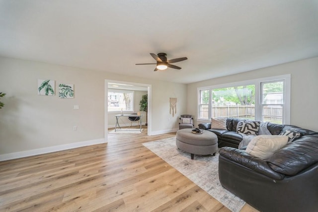 212 Nile Kinnick Dr N, Adel, IA 50003 - living area with ceiling fan, light wood-style floors, and baseboards